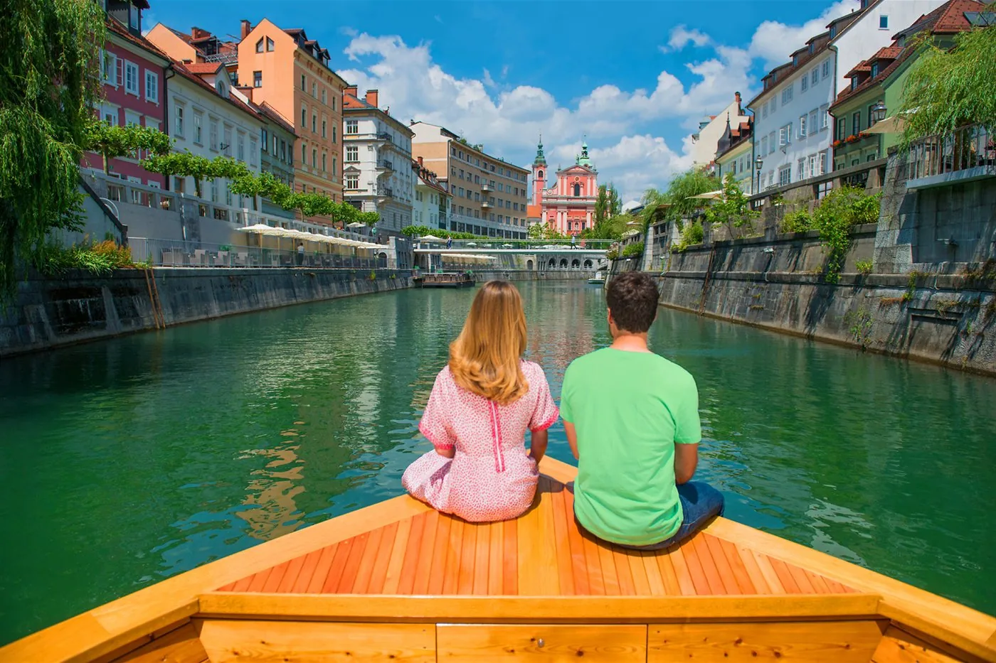 People spending time beside the Ljubljanica River in central Ljubljana